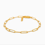 Gold chain link bracelet on a white background