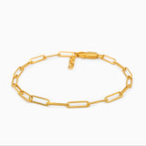 Gold chain link bracelet on a white background