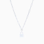Silver chain link necklace with padlock on cream background