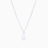 Silver chain link necklace with padlock on cream background