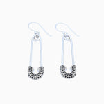 safety pin earrings on white background