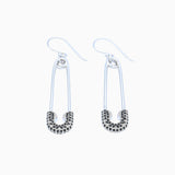 safety pin earrings on white background