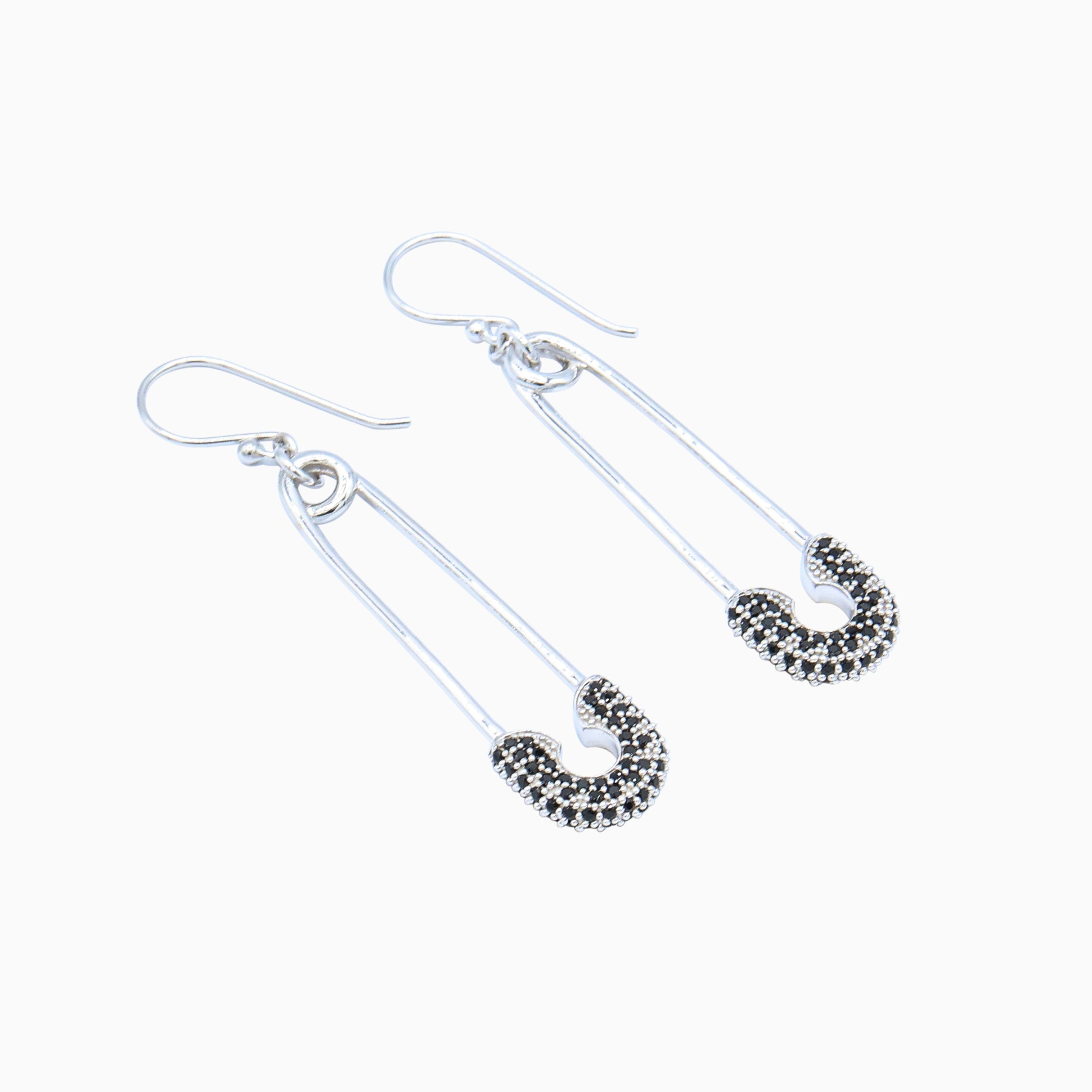 Silver safety pin earrings on a white background